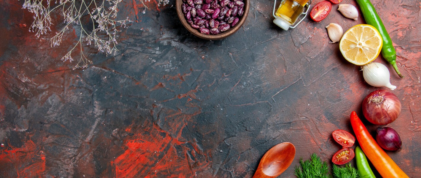 dinner-preparation-with-oil-bottle-beans-lemon-bunch-green-mixed-color-table